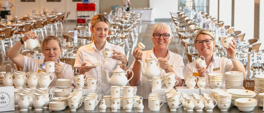 Duchess China employees display JCB-branded fine bone china at the Stoke-on-Trent factory